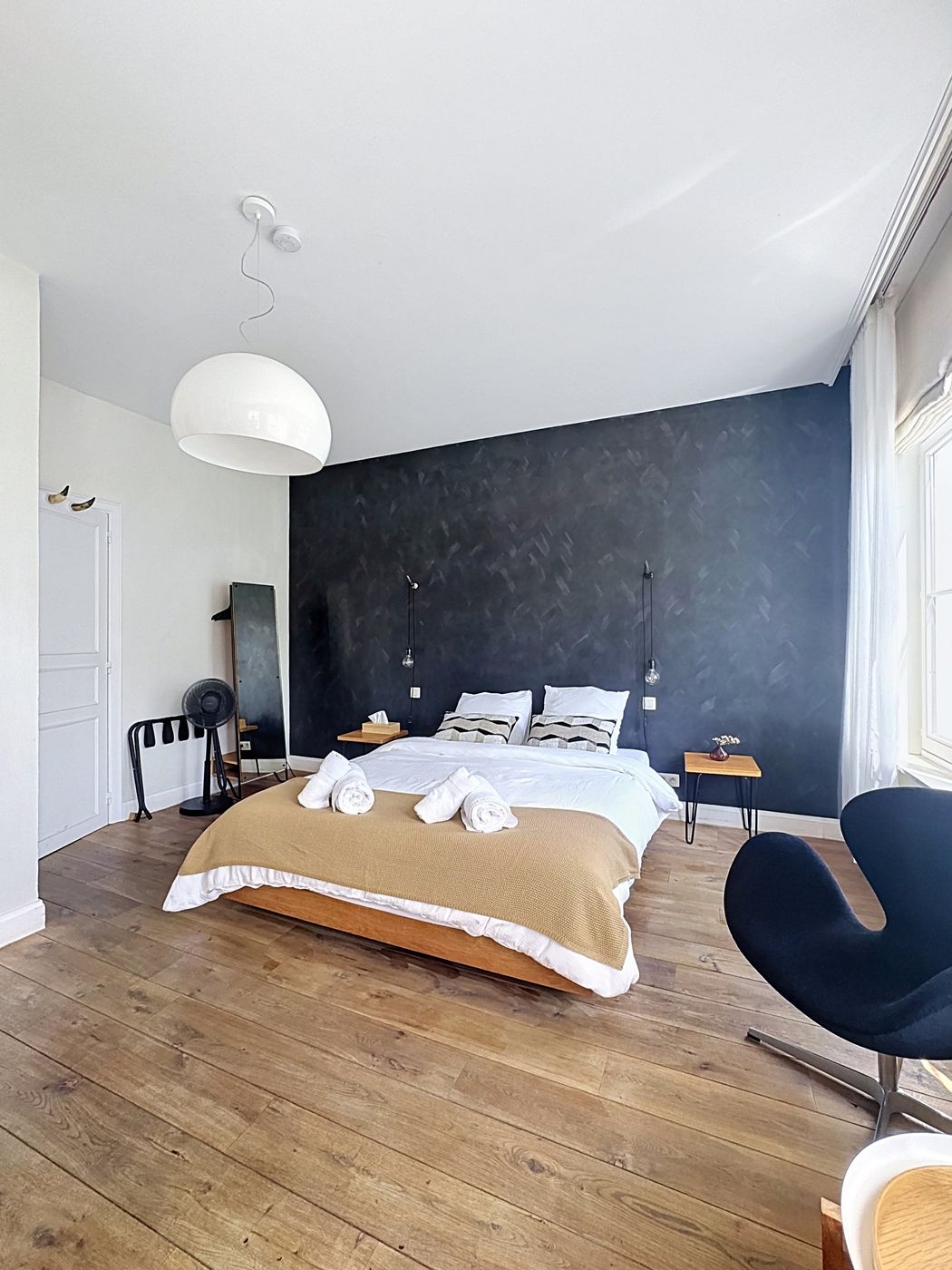 Canal Room — bed against the charcoal wall