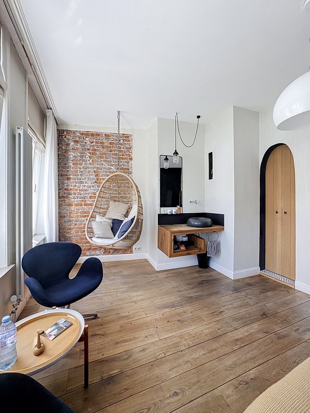 Canal Room — hanging chair and exposed brick