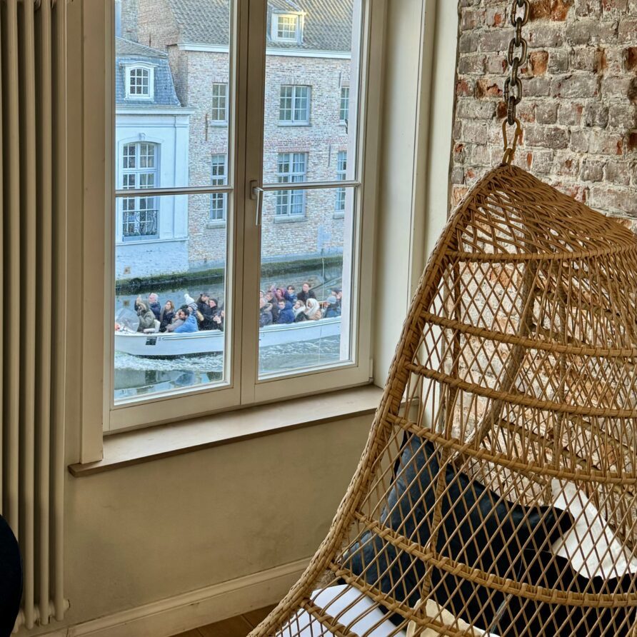 Canal Room — a boat passing on the canal, seen from the chair by the window