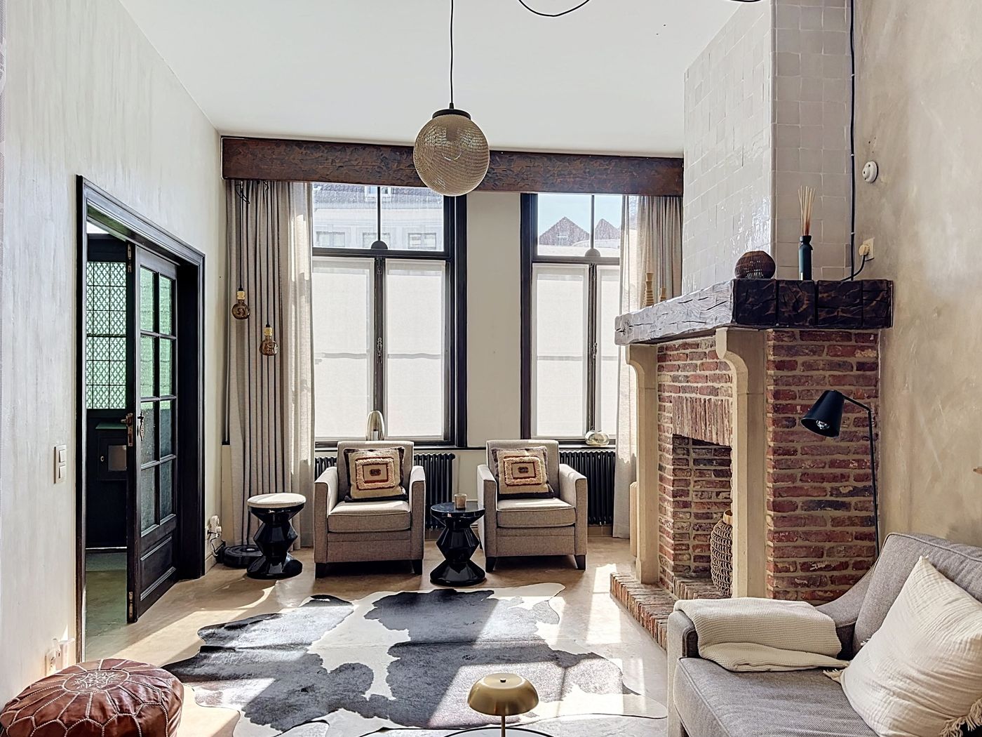 Armchairs by the tall windows in the lounge