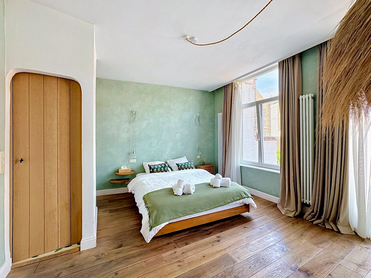 Terrace Room — bed against the green wall